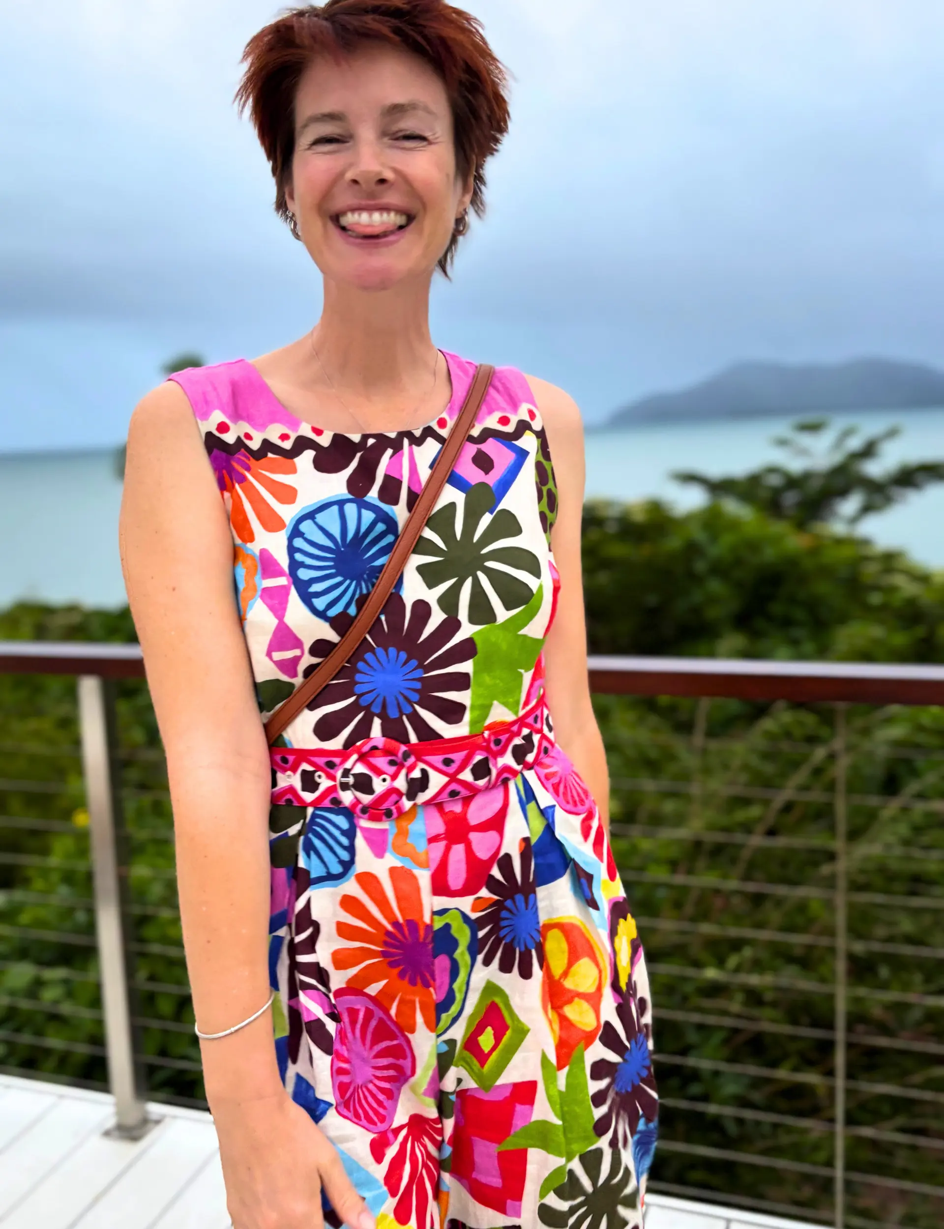 Sarah Rus, Melbourne Relationship and Leadership Coach, smiling in a floral dress by the coast